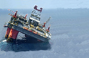 oil rig tilting and sinking in ocean