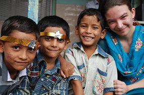 Three Indian children with caucasian woman all smiling